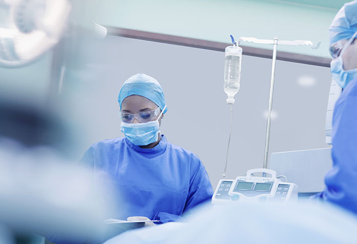 Doctors performing surgery in hospital operating room